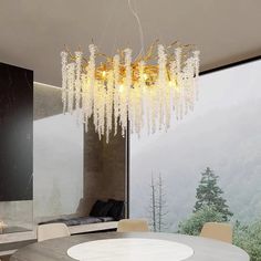 a dining room table with chairs and a chandelier hanging from the ceiling over it