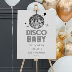 a disco baby welcome sign in front of balloons