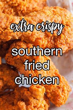 some fried chicken is on a plate with the words extra crispy southern fried chicken