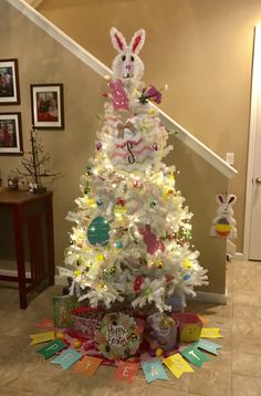 a white christmas tree decorated with bunny decorations