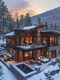 a large house in the middle of a snowy forest with trees and rocks around it