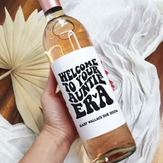 a person holding a bottle of wine with the words welcome to your favorite expa