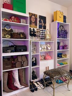 a room filled with lots of purses and handbags on shelves next to a bench