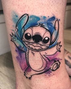 a cartoon character tattoo on the leg of a person's leg, with space in the background