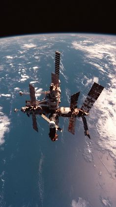 the international space station as seen from orbit, looking down on earth's horizon