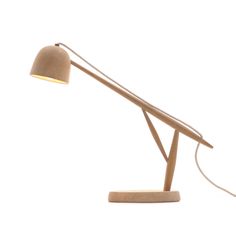 a wooden desk lamp on a white background with a cord attached to the light fixture