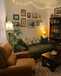 a living room with two couches, a coffee table and some pictures on the wall