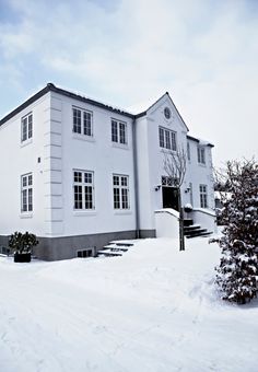 a large white building sitting on top of snow covered ground