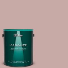 the behr marquee paint is shown in an open, dark green color