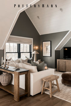 a living room filled with furniture and a flat screen tv on top of a wooden table