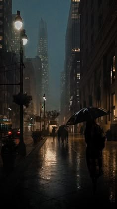 people walking in the rain with umbrellas on a city street at night under tall buildings