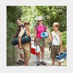 four people standing on a path with backpacks and one holding a blue object in the other's hand