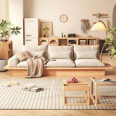 a living room filled with lots of furniture and decor on top of a hard wood floor