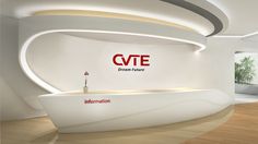 a large white reception area with a curved counter and logo on the wall above it