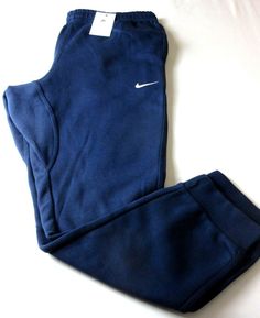 Nike Club Men's Tapered Leg Fleece Lined Jogger pants Midnight Navy Blue NWT Ships Free.  Nike Club Men's tapered leg fleece lined jogger pants.  Brand new with all original tags. "Midnight Navy Blue" in color with 2 front pockets and 1 pocket in the back that snaps.  These pants are standard fitting with tapered leg design and regular length.  Nike Swoosh logo on the front.  Super versatile, lightweight and comfortable, these pants are soft cotton and  Polyester in material.   As always we guarantee authenticity. Nike style # 716830-410.  Fast and Free U.S. shipping to your door.  Please message us with any questions.  Thanks! PLEASE NOTE, WE DO OUR BEST TO MAKE YOUR EBAY BUYING FROM US AS EASY & SMOOTH AS POSSIBLE. IF YOU SHOULD HAVE ANY ISSUES WITH YOUR PURCHASES, PLEASE CONTACT US 1'ST Nike Style, Nike Swoosh Logo, Swoosh Logo, Nike Fashion, Nike Swoosh, Leg Design, Midnight Navy, Tapered Legs, Jogger Pants