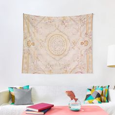 a living room with a white couch and colorful pillows on the table in front of it