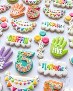 decorated cookies are displayed on a table for a birthday party or special occasion to celebrate