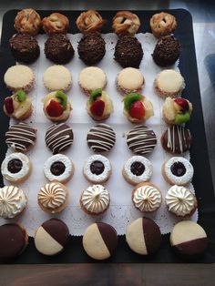 an assortment of pastries are displayed on a tray