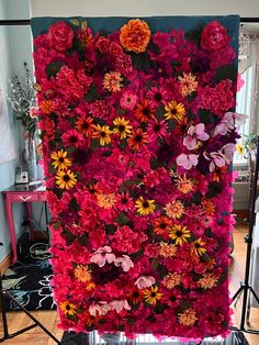 a large display of flowers is displayed on a tripod