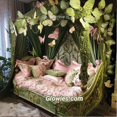 a green bed with pink pillows and butterflies on it