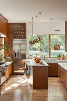 a modern kitchen with wooden cabinets and stainless steel appliances, along with an island in the middle