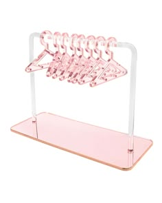 pink acrylic hair rack with five combs in it on a white background