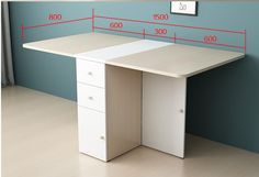 an office desk with measurements on the wall