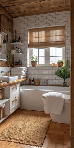 a bathroom with white walls and wooden flooring next to a bathtub in the corner