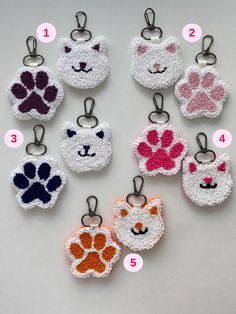 crocheted key fobs with different colors and designs for each dog's paw