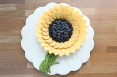 a white plate topped with fruit and crackers