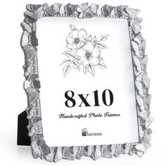 the 8x10 photo frame is made out of silver foil and has flowers on it