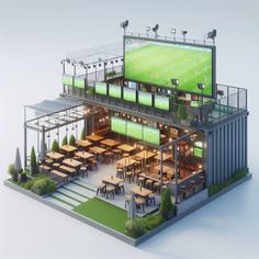 a large building with tables and chairs in front of it that has a soccer field on the wall