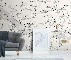 a living room with a chair and wallpaper that has stars in the sky on it