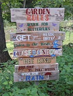 a wooden sign that says garden rules on it in front of some trees and grass