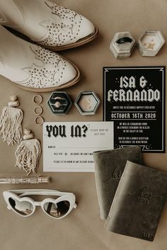 the wedding stationery is laid out on top of the bed, including shoes and jewelry