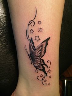 a small butterfly tattoo on the ankle and leg, with stars in the sky above it