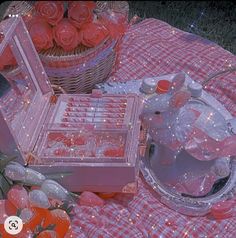 a table topped with lots of pink roses next to a basket filled with red roses