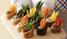 a person holding a tray with sushi and vegetables on it while wearing a tie