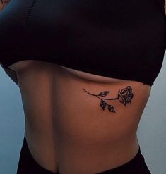 a woman with a rose tattoo on her stomach