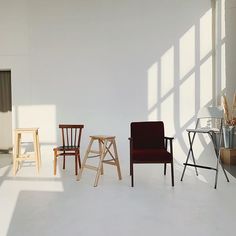 three chairs are lined up against the wall in an empty room with sunlight coming through the windows