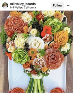 an arrangement of flowers in a vase on a table