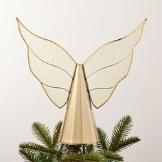 a golden angel decoration on top of a christmas tree