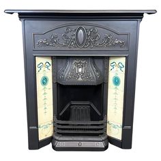 a black fireplace with ornate designs on the top and bottom panel, in front of a white background