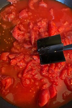 the sauce is being stirred with a spatula