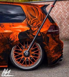 an orange car with the image of gohan painted on it's front wheel