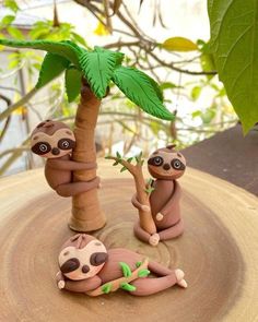 three slotty figurines sitting on top of a tree