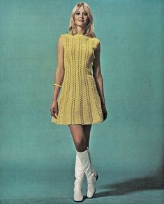 a woman in a yellow dress and white boots is posing for a magazine cover photo