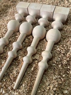 several wooden spoons are lined up on the ground