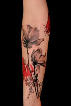 a woman's arm with flowers on it