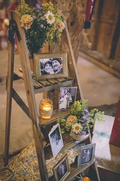 a wooden ladder with pictures and flowers on it